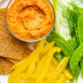 roasted red pepper and white bean dip on plate with vegetables
