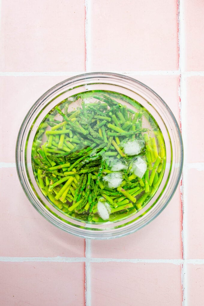 chopped asparagus in ice bath