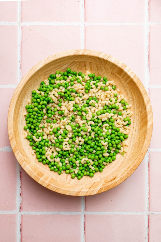 peas and pasta in wooden bowl
