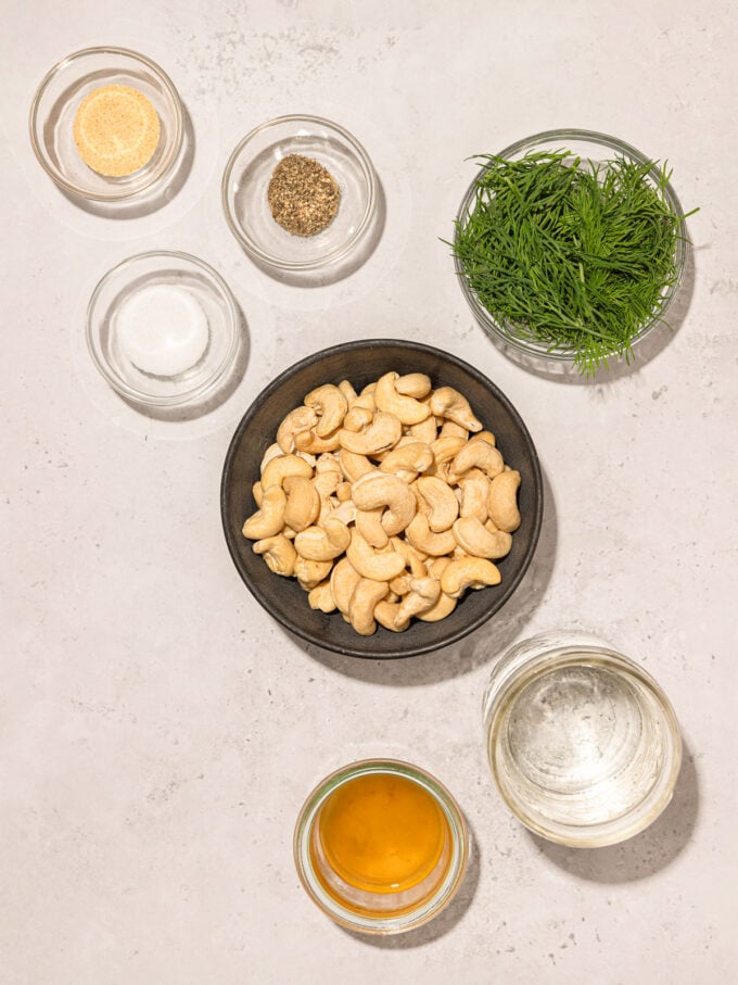 cashews and dill in bowls with spices