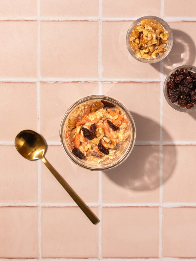 carrot cake overnight oats with gold spoon and walnuts