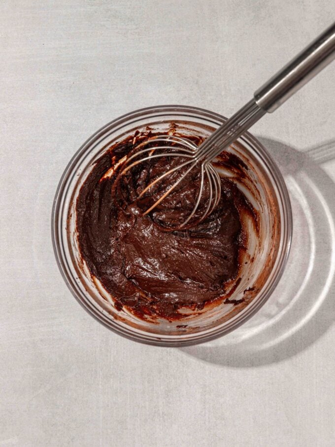 vegan chocolate dip in bowl with whisk