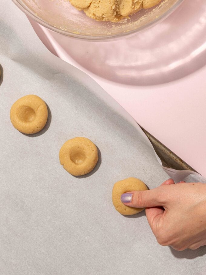 pressing thumbprint cookies
