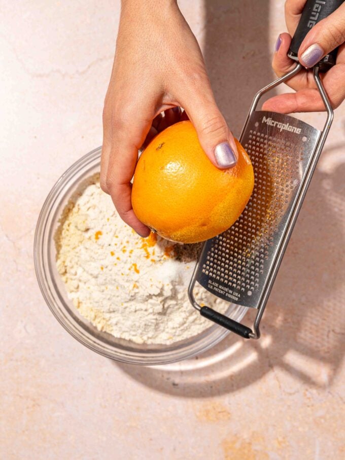 hand zesting orange