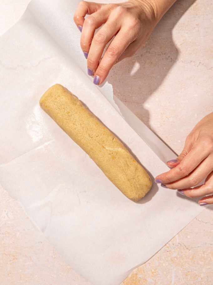 hand folding parchment over dough